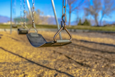 Close-up of swing hanging in playground