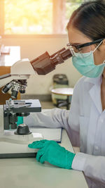 Close-up of scientist examining in laboratory