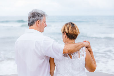 Senior couple standing at beach