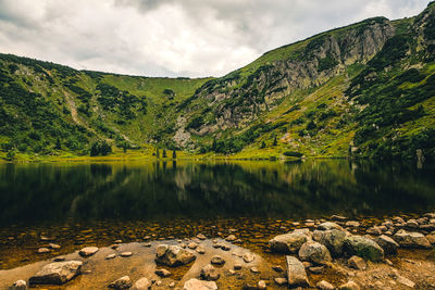 Scenic view of lake and mountains against sky