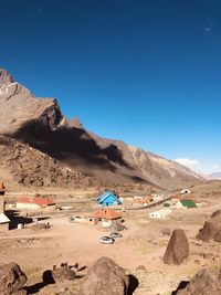 Scenic view of desert against clear blue sky