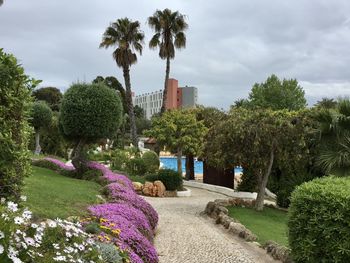 Scenic view of park against cloudy sky