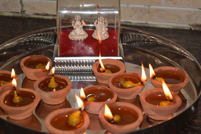 High angle view of illuminated candles in temple