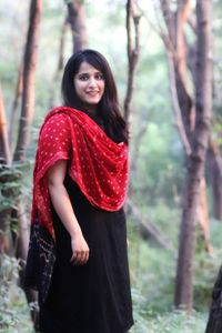 Portrait of smiling young woman standing outdoors