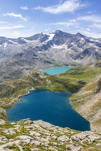 Scenic shot of calm countryside lake against mountain range