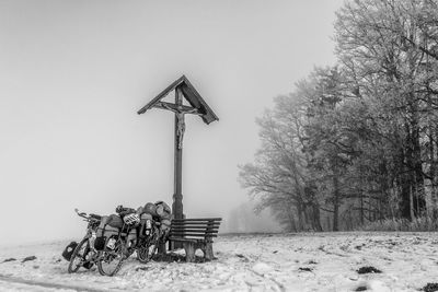 Traditional windmill on field against sky during winter