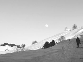 People on snowcapped mountain against sky