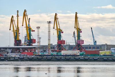 Massive harbor cranes in seaport. cranes in port, cargo container yard, container ship terminal