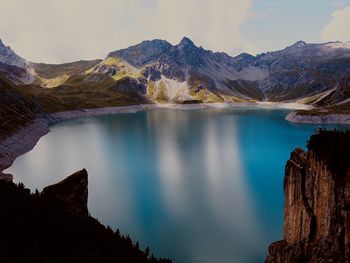 Scenic view of lake against cloudy sky