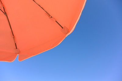 Low angle view of hot air balloon against clear blue sky