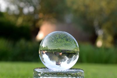 Close-up of crystal ball on glass