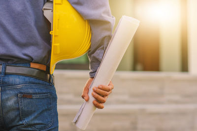 Midsection of man working with mobile phone