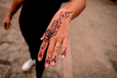 High angle view of woman hand with tattoo