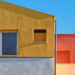 Low angle view of house against clear blue sky