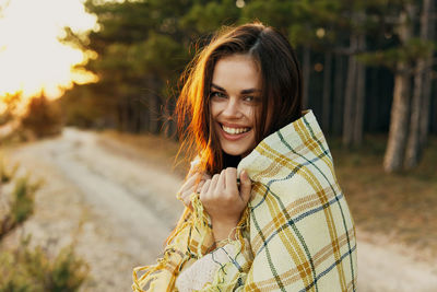 Portrait of smiling young woman outdoors
