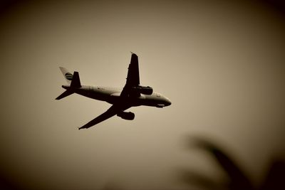 Low angle view of airplane against clear sky