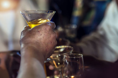 Close-up of hand holding beer glass