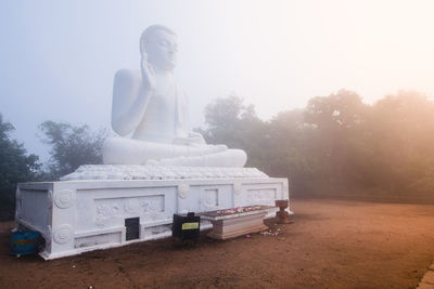 Statue of buddha against clear sky