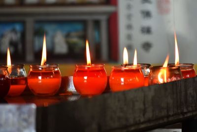 Close-up of illuminated candles on table