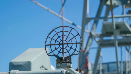 Low angle view of metallic structure against clear blue sky