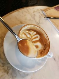 High angle view of cappuccino on table