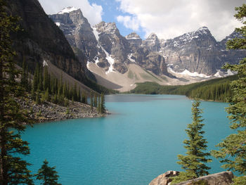 Moraine lake in canada on a sunny summer day with snow capped mountains in the background