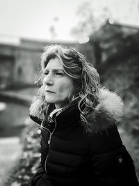 Mature woman looking away outdoors during winter