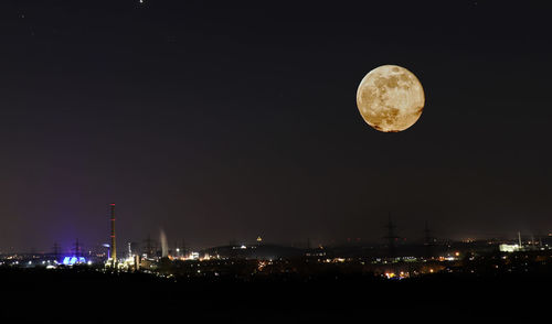 Illuminated moon against sky at night