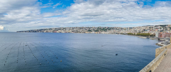 Scenic view of sea against sky in city