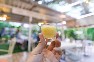 Close-up of hand holding drink at restaurant