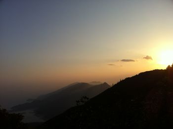 Scenic view of silhouette mountains against sky during sunset
