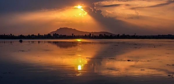 Scenic view of sea against orange sky