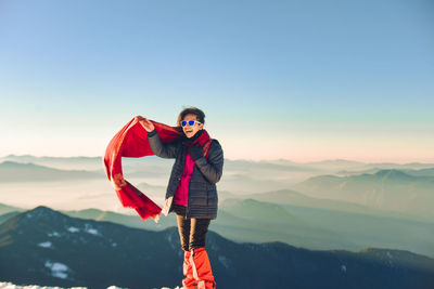 Portrait of man standing on mountain against sky