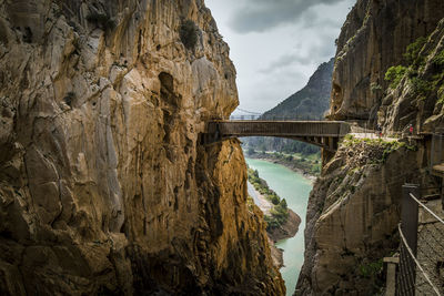 Scenic view of river amidst rocky mountains against sky