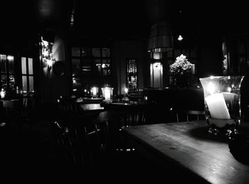 Empty chairs and tables at night