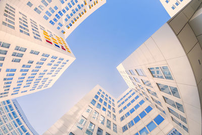 Low angle view of buildings against clear blue sky