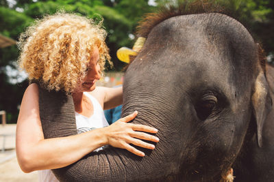 Smiling woman with elephant 