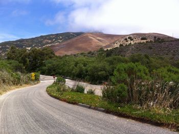 Empty road with mountains in background