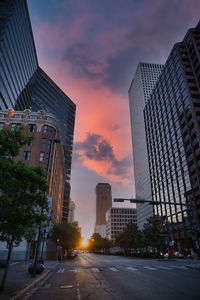 Low angle view of skyscrapers against sky during sunset