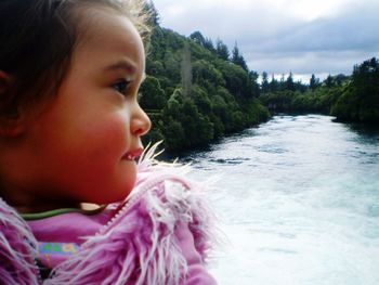 Close-up of girl against sky