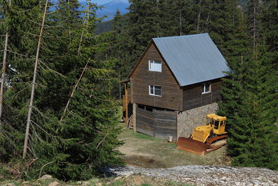 House amidst trees and plants in forest
