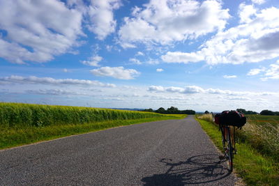 Road by landscape against sky