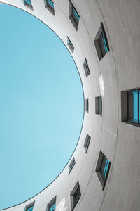 Low angle view of buildings against clear blue sky