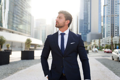 Businessman standing outdoors in city