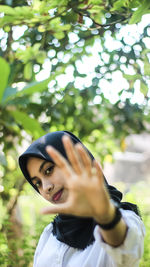 Portrait of woman against plants