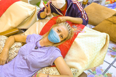 High angle view of woman lying on bed