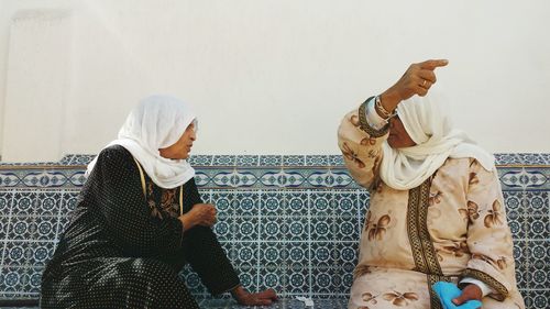 Midsection of man and woman standing on cross