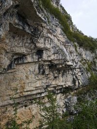 Low angle view of rock formation against sky