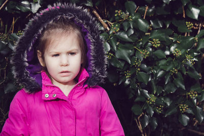 Close-up of cute girl against plants