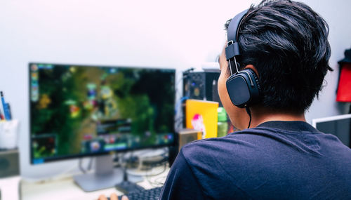 Rear view of man using mobile phone